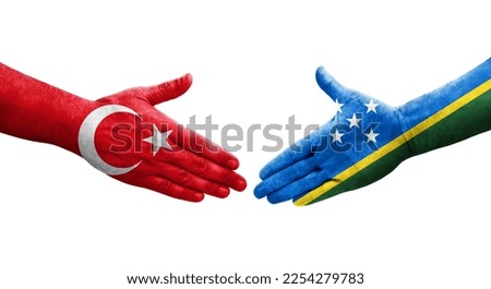 Handshake between Solomon Islands and Turkey flags painted on hands, isolated transparent image.