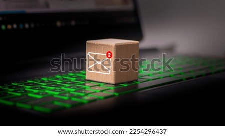 New email symbol on wooden block on laptop keyboard.