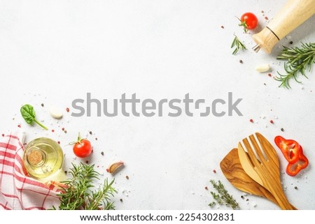 Food background with spices, herbs and utensil on white background. Royalty-Free Stock Photo #2254302831