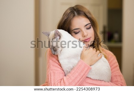 Gorgeous young brunette woman with beautiful cat.