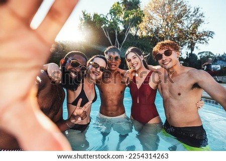 Selfie, peace sign and friends at pool party having fun partying on new year. Swimming celebration, water event and group portrait of people with hand gesture, laughing and taking social media photo