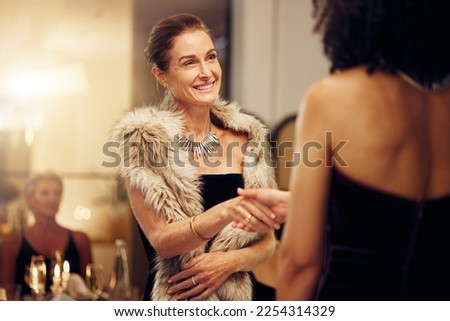 Success, handshake or women in a party shaking hands for partnership agreement at social event. Thank you, congratulations or happy people greeting or meeting at luxury dinner gala for winning a deal Royalty-Free Stock Photo #2254314329