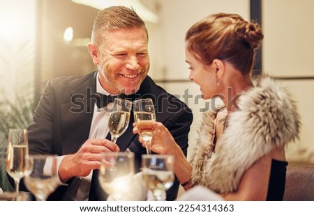Success, toast or couple in a party in celebration of goals, achievement or new year at luxury event. Motivation, smile or happy people cheers with champagne drinks or wine glasses at dinner gala Royalty-Free Stock Photo #2254314363