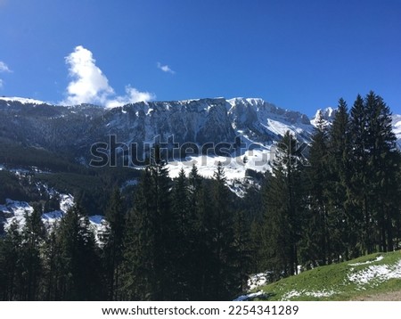 Photo of mountains covered with snows.