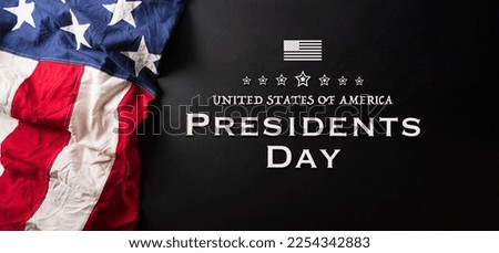 Happy presidents day concept with flag of the United States and the text on dark  background.