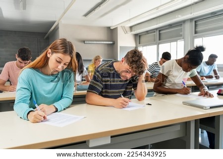 Multi ethnic teenager students taking exam at High School - Technical preparation course for University