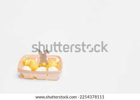 Happy Easter. Easter colored eggs in a basket on the table. copy space. photo