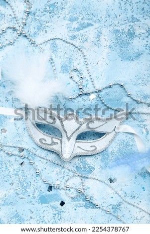 Carnival mask with beads and confetti on grunge background