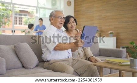 Portrait of happy smiling Asian old couple senior elderly patient using technology tablet device, woman person in hospital in medical healthcare concept. People lifestyle. Family wife and husband Royalty-Free Stock Photo #2254381959