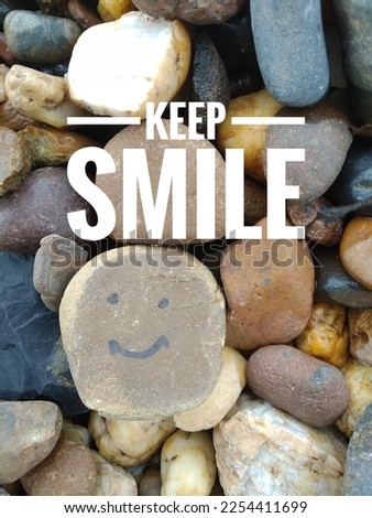 keep smile on the pebbles with a picture of a smile using a marker on the gravel