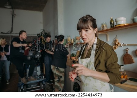 Director at work on the set. The director works with a group or with a playback while filming a movie, advertising, or a TV series. Shooting shift, equipment and group. Modern photography technique.