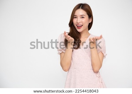 Happy Asian woman presenting or showing open hand palm with copy space for product isolated over white background
