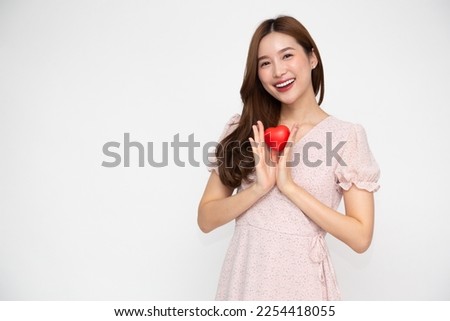 Young Asian woman holding red heart isolated on white background, Valentine day concept