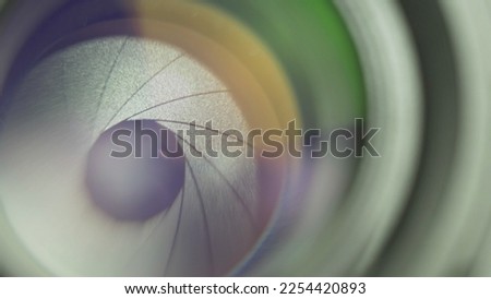 Detail of camera lens iris blades opening to adjust exposure