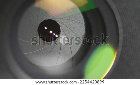 Photo lens diaphragm blades opening to let light go in