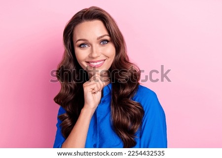 Photo of gorgeous satisfied positive woman curly hairdo dressed blue blouse hold arm on chin smiling isolated on pink color background