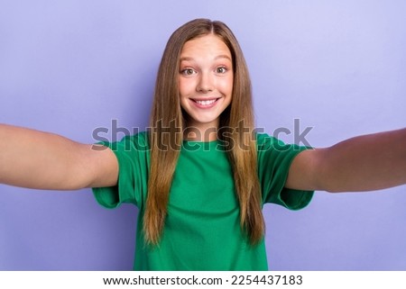 Photo of cheerful lovely lady blogger making picture recording instagram facebook post isolated on purple color background