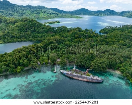 Mother Nature is slowly reclaiming the World Discoverer, a cruise ship that was shipwrecked in the Solomon Islands. The ship struck a reef on April 30, 2000, and was run aground in the Nggela Islands. Royalty-Free Stock Photo #2254439281