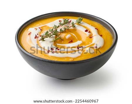 vegetable cream soup decorated with chili flakes and thyme isolated on white background Royalty-Free Stock Photo #2254460967
