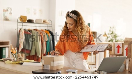 Black woman, package check and fashion e commerce start up. Small business owner, online retail brand supplier and digital store supply chain delivery confirmation with laptop on store Royalty-Free Stock Photo #2254461749