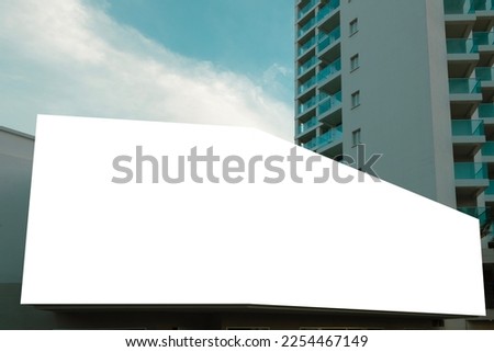Blank white big mockup advertising sign above entrance of shop, hotel, office building. Empty banner mock up template outdoors