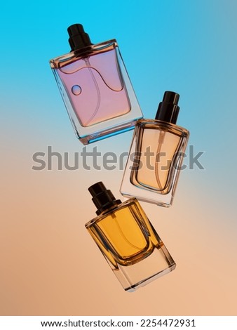 Levitation of set of perfume bottles on a gradient background Royalty-Free Stock Photo #2254472931