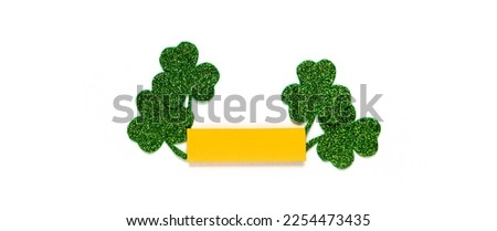 Happy St. Patrick's Day banner.Holiday background.St Patricks Day frame against a white background. Flat lay shamrocks.Copy space.Patrik's day banner Royalty-Free Stock Photo #2254473435