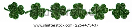Happy St. Patrick's Day banner.Holiday background.St Patricks Day frame against a white background. Flat lay shamrocks.Copy space.Patrik's day banner Royalty-Free Stock Photo #2254473437