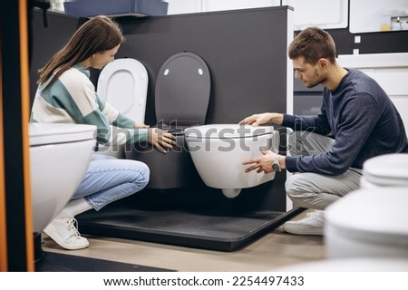 Couple choosing home toilet in store Royalty-Free Stock Photo #2254497433