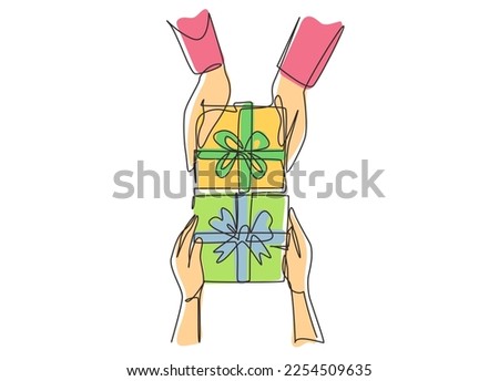Single one line drawing gives gift new year presents laid on wooden table background. Birthday presents cardboard box with ribbon bow. Modern continuous line draw design graphic vector illustration