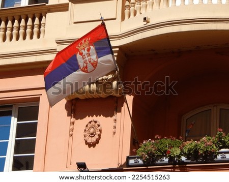 Serbia flag. Serbian flag displaying on a pole on the balcony. National flag of Serbia waving