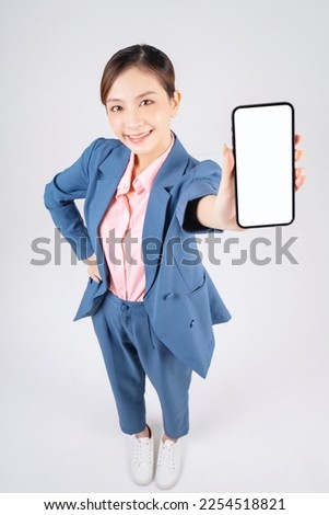 photo of young Asian business woman using smartphone