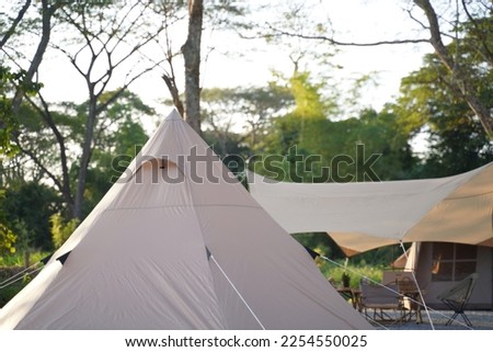 Tent in the yard. Camper while campsite in nature background at summer trip camp.