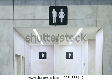 Entrance to a public toilet. Two doors to the public toilet for women and men. Indicative sign for toilet cubicles for men and women. Royalty-Free Stock Photo #2254558147