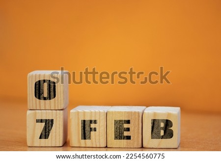 Cube shape calendar for February 07 on wooden surface with empty space for text, new year Wooden calendar with date, January cube calendar on wooden surface with copy space.