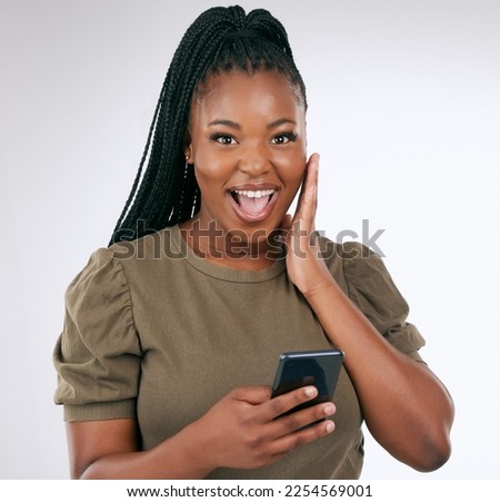 Black woman, surprise face in portrait with smartphone, wow facial expression isolated on gradient background. Happy in studio, notification on social media or email, alert or announcement with shock Royalty-Free Stock Photo #2254569001