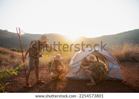 Asian Boy Scouts go camping, adult mentor guides group of Boy Scouts hiking at wild nature sunset photo background