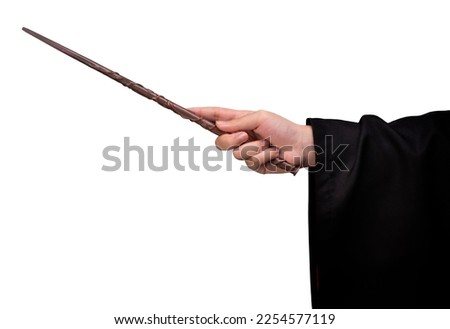 Miracle magical wand stick, Teens hand holding a wand wizard conjured up in the air on white background. Royalty-Free Stock Photo #2254577119