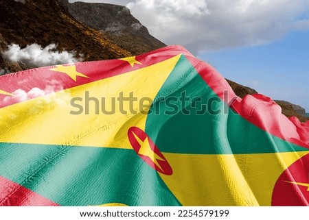  Grenada  national flag cloth fabric waving on beautiful mountain background.