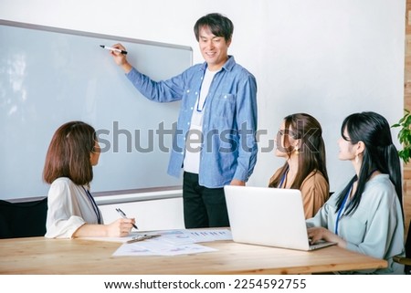Female staff and men participating in a study session Royalty-Free Stock Photo #2254592755