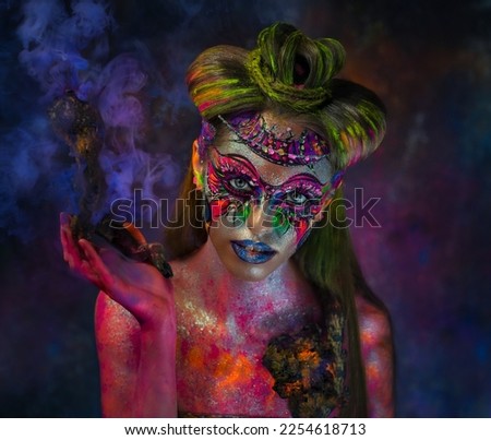Ultraviolet. Photo shoot with neon colors. Neon makeup. Fluorescent body painting. A native from space. Galactic makeup.