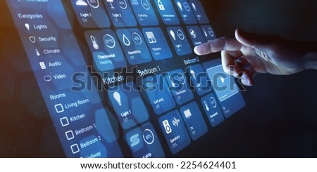 Smart home dashboard to control smart devices and set up home automation technology. Assistant for connected devices, smart lock, lights, thermostat. Finger touching button on virtual interface. Royalty-Free Stock Photo #2254624401