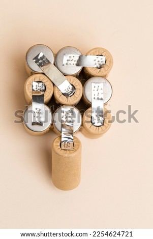 Energy and Environment Ideas. Upper View of Bundle of Soldered Ni-Mh Rechargeable Batteries  Placed Together Over Beige.Vertical Image Royalty-Free Stock Photo #2254624721