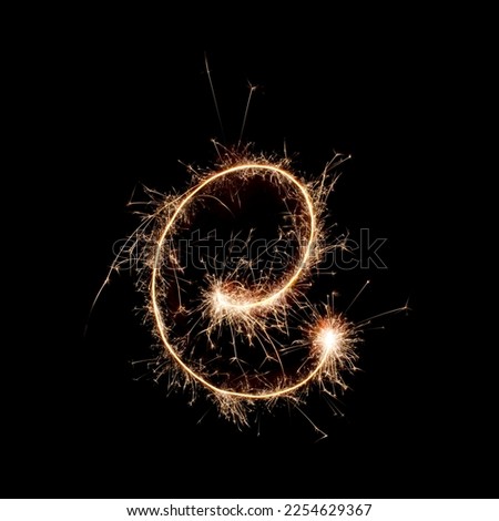 Sparkling burning creative letter E isolated on black background. Beautiful glowing golden overlay object for design holiday greeting card. Creative lettering E written with burning sparklers