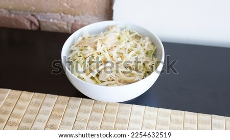 Bowl with white cabbage salad in a restaurant.