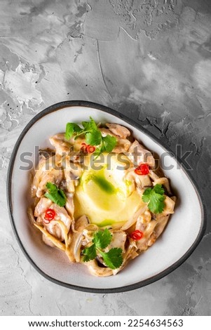 Fried rapana meat in cream sauce with mashed potato Royalty-Free Stock Photo #2254634563