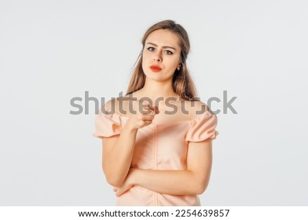 Hey, You. Angry Serious brunette woman pointing finger at camera, blaming you. Indoor studio shot on white background Royalty-Free Stock Photo #2254639857
