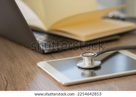 Medical  healthcare  network on Computing electronic medical record. Doctor working an Laptop with Stethoscope