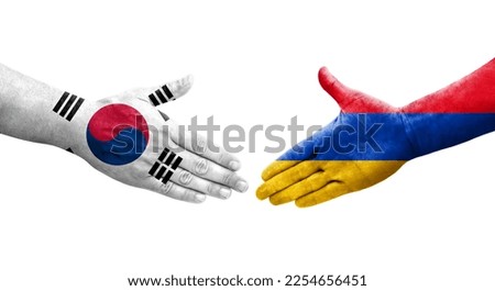 Handshake between South Korea and Armenia flags painted on hands, isolated transparent image.