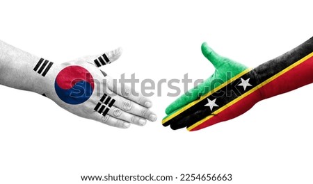Handshake between South Korea and Saint Kitts and Nevis flags painted on hands, isolated transparent image.